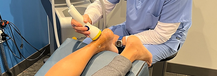 Kurt O'Neill Performing Shockwave Therapy On A Patient's Foot