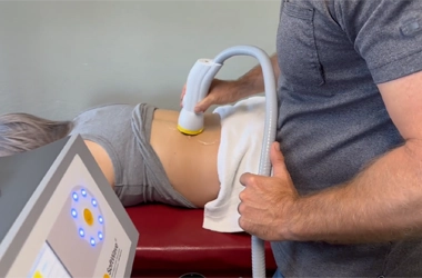 Shockwave Applicator Being Used On Patient's Back