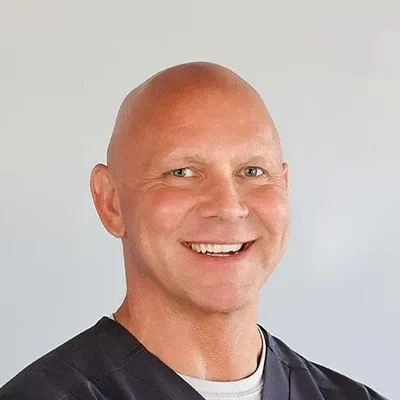 Kurt O'Neill Smiling In Black Scrubs