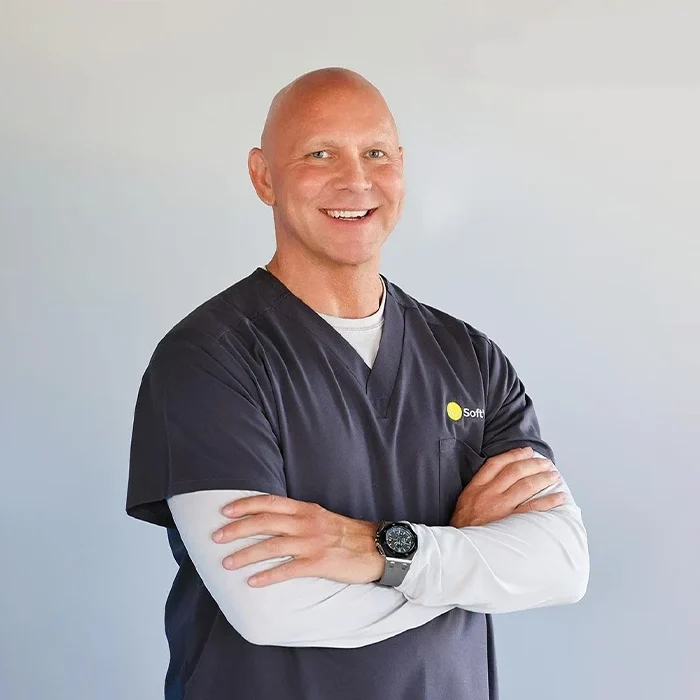 Kurt O'Neill Standing Smiling In Black Scrubs